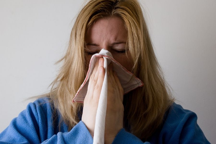 Person experiencing allergic reaction symptoms from mold exposure